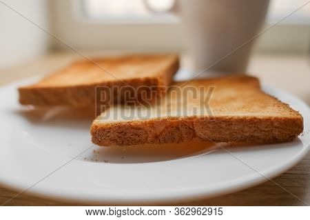 Freshly Baked Toaster Bread. Tasty Toasted Bread On Wooden Board. A Couple Of Crusty Toasts In The T