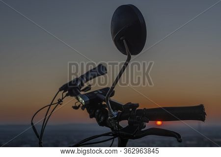 Handlebar Mirror And Light On Electric Bike In Sunset Color Evening