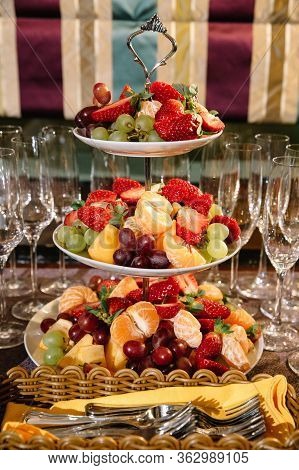 Three-tier Modern Dish With Yellow Brass Plates And A Rod With A Brass Ring Handle For Desserts Or S