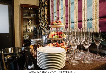 A Three-tier Modern Dish With Yellow Brass Plates And A Rod With A Ring Handle. For Desserts Or Snac