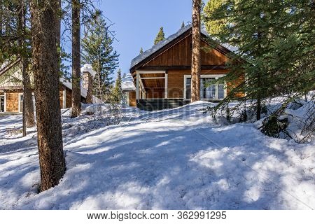 Banf, Canada - March 20, 2020: Vacation Cabins In Winter Park Between Trees In Johnston Canyon.