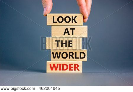 Look At The World Wider Symbol. Concept Words Look At The World Wider On Wooden Blocks On A Beautifu