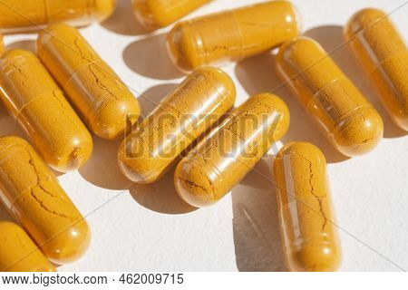 Turmeric Plus Black Pepper Extract Gelatin Capsules Close Up Top View. Herbal Supplement Organic Cur