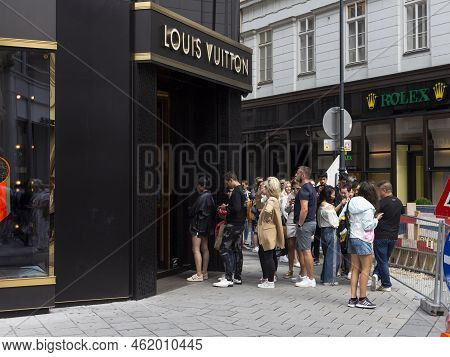 Vienna, Austria - August 16, 2019: Louis Vuitton Store. People Waiting In Line To Get Inside. Golden