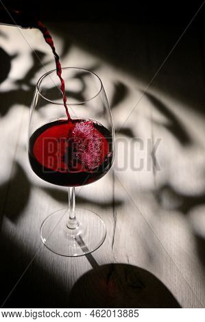 Abstract Shadows, Sunlight And Glass Of Dry Red Wine