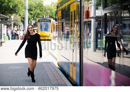 Fashionable Woman Running After Bus Trolleybus And Pulling Trolley Case On The Street, Fashion Stree