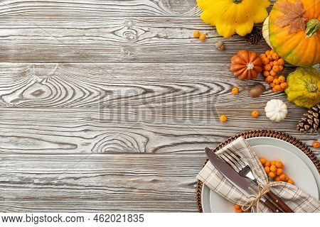 Thanksgiving Day Concept. Top View Photo Of Plate Napkin Cutlery Raw Vegetables Pumpkins Pattypans P