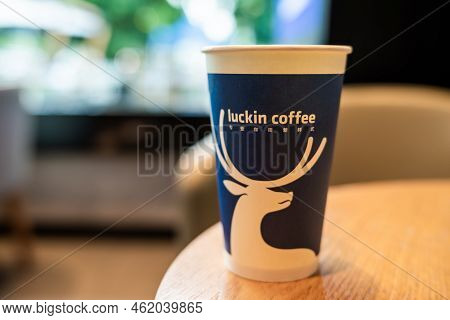 Chengdu, Sichuan Province, China - Sept 21, 2022: A Cup Of Coffee On A Wooden Table In Luckin Coffee