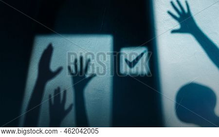 Freedom, Expression And Voting Concept. Shadow Of Diversity People Rasing Hands Up For Express Human
