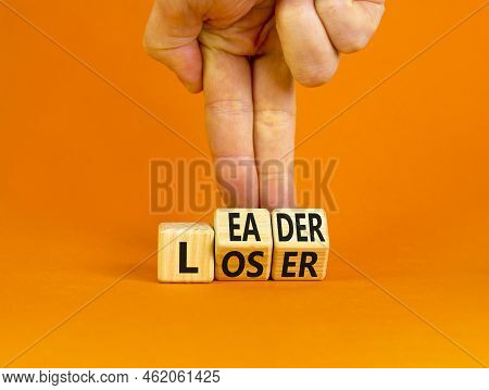 Loser Or Leader Symbol. Concept Words Loser Or Leader On Wooden Cubes. Businessman Hand. Beautiful O