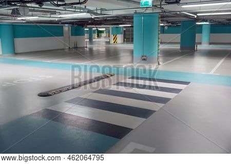Empty Car Parking Garage With Pedestrian Crossing And Columns