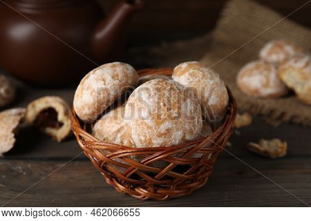 Tasty Homemade Gingerbread Cookies In Wicker Basket On Wooden Table