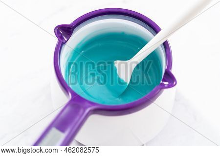 Melting Chocolate Melts In A Candy Melting Pot To Prepare Mermaid Cakesicles.
