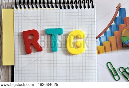 Rtg (real-time Guaranteed) - Acronym In Multi-colored Letters Lies On The Notebook On The Background