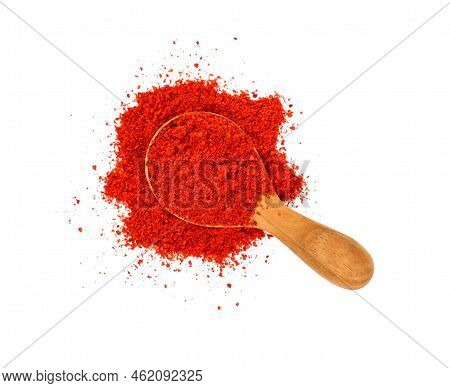Close Up One Wooden Scoop Spoon Full Of Red Chili Pepper, Paprika Or Sundried Tomato Powder Spilled 