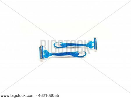 Two Brand New Blue And White Plastic Disposable Razors With Ergonomic Handle Isolated On White Backg
