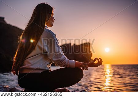 Young Woman With Long Hair In Sportswear And Boho Style Braclets Practicing Outdoors On Yoga Mat By 