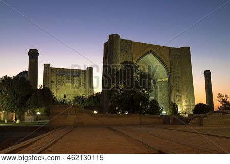A View Of The Medieval Bibi Khanum Madrasah Against The Backdrop Of Sunset. Samarkand, Uzbekistan