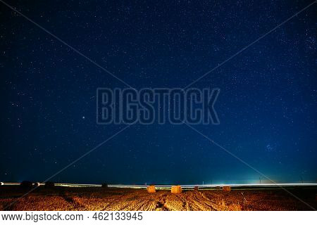 Agricultural Colorful Background Copy Space. Night Starry Sky Above Rural Landscape Field Meadow Wit