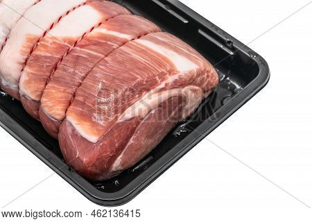 Close Up A Raw Cut Of Pork Loin, Tied Up And Rolled With Butcher's String In A Black Plastic Contain