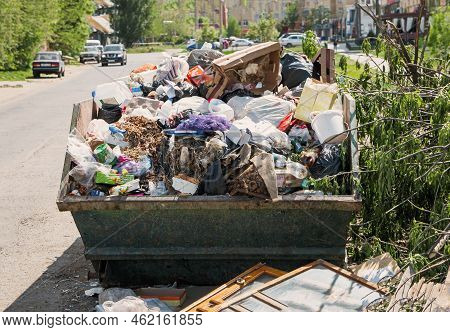 Overfilled Dumpster In Ghetto, Trash Needs Recycling. Environment Pollution.