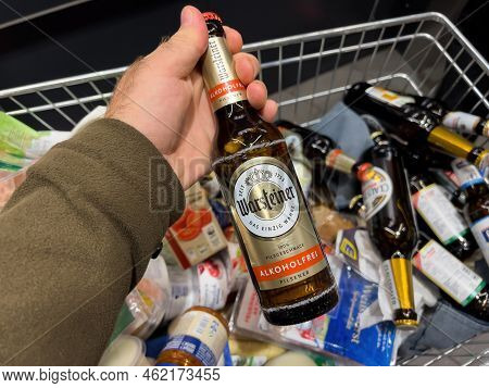 Frankfurt, Germany - Sep 17, 2022: Pov Male Hand With A Full Shopping Cart Of Groceries At A Conveni
