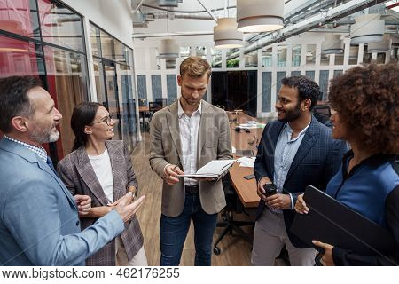 Multiethnic Group Of Business People Talking In Office During Break. Teamwork Concept