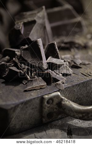 Pieces Of Dark Chocolate  On A Wooden Background