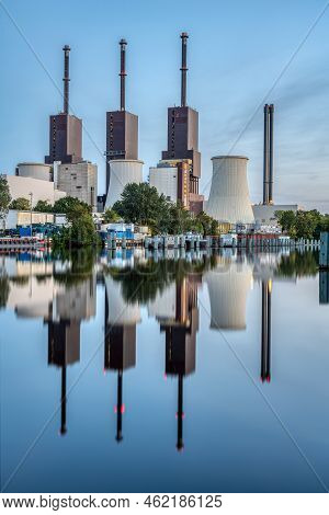A Thermal Power Station In Berlin At Dusk Reflected In A Canal
