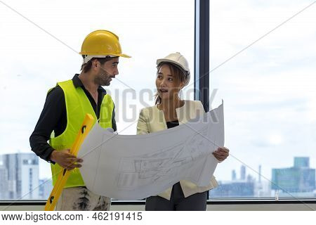 Team Engineers With Draft Plan Of Building On Constructing Site. Engineer Work On Site. Engineer Vis