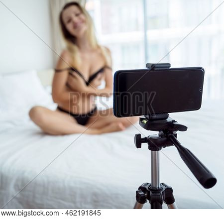 Young Sexy Woman Posing In Front Of Camera And Working As Webcam Model