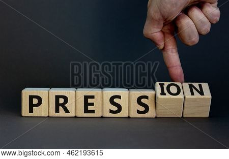 Pression To Free Press Symbol. Businessman Turns Wooden Cubes And Changes The Word Pression To Press