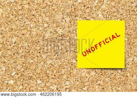 Yellow Note Paper With Word Unofficial On Cork Board Background With Copy Space