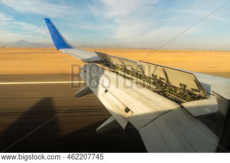 The Wing Of An Aircraft With Open Flaps On The Wing That Is Landing. The Wing Of A Passenger Aircraf