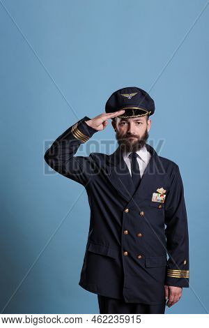 Confident Airplane Aviator Saluting, Wearing Uniform And Hat Front View Portrait, Plane Captain Look