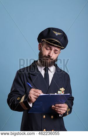Airplane Pilot Holding Clipboard, Filling Form, Concentrated Aviator With Documents. Aircraft Captai