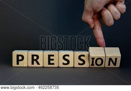 Pression To Free Press Symbol. Businessman Turns Wooden Cubes And Changes The Word Pression To Press
