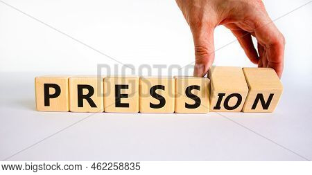 Pression To Free Press Symbol. Businessman Turns Wooden Cubes And Changes The Word Pression To Press