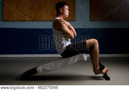 19 Year Old Teenage Boy Doing Situps On An Excercise Bench In A Tank Top