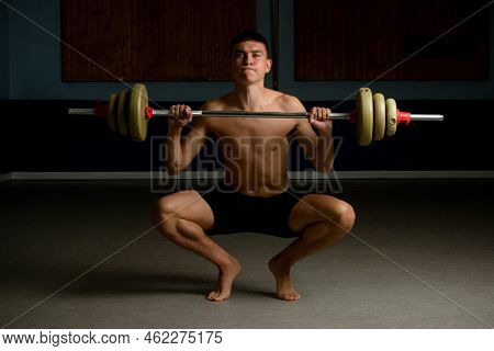 Shirtless 19 Year Old Teenage Boy Lifting A Barbell