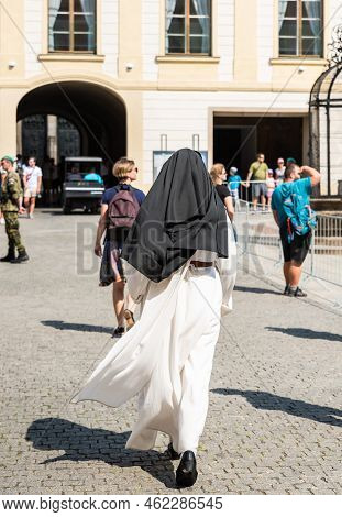 Prague - Czech Republic - 08 01 2020 A Catholic Nun Walking Towards The Saint Vitus Cathedral Of The