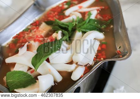 Steam Squid With Spicy Chili And Lemon Sauce  On Iron Fish Shaped Hot Plate - Pla Muk Nung Manow. Se