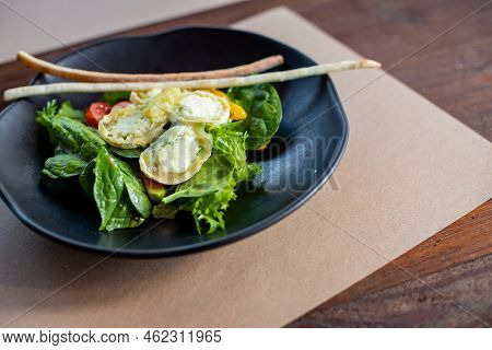 Breakfast In The Morning, Creamy Omelet And Buratta Chesese, Salad Avocado And Green Leaves On Black