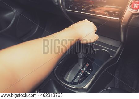 Shot Of Young Man Driving Luxury Car Hand Shifting The Gear Stick.