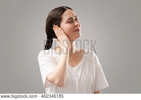 Portrait Of Young Caucasian Woman Holds Her Ear With Her Palm. The Concept Of Hearing Loss, Otitis M