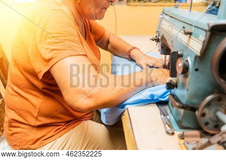 Unrecognizable Latin Elderly Woman Working On A Sewing Machine
