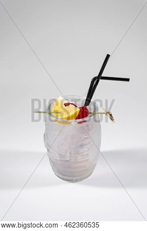 Kamikaze Cocktail In Tiki Glass With Vodka, Triple Sec, Lemon And Cherry