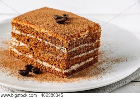 Traditional Italian Dessert Tiramisu On Light Background. Close-up Tiramisu Cake Decorated With Coff