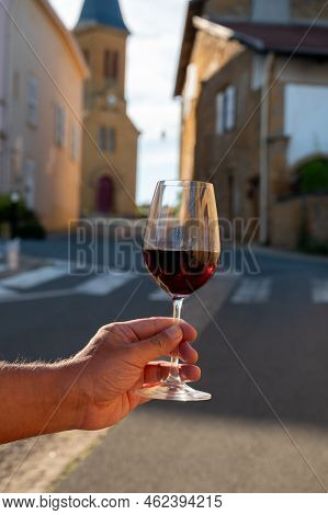 Tasting Of Red Wine By Old Wine Maker In Pierres Dorées Region With Yellow Stone Houses On South Of