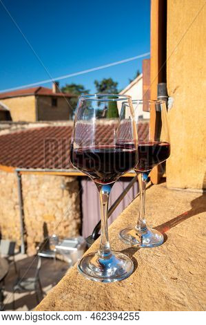 Tasting Of Red Wine By Old Wine Maker In Pierres Dorées Region With Yellow Stone Houses On South Of